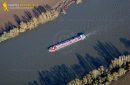 Barge on the Seine river seen from the sky at Haute-Isle en Vexin in Val de Seine