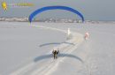 Aerial view of paramotor following a road in winter in France